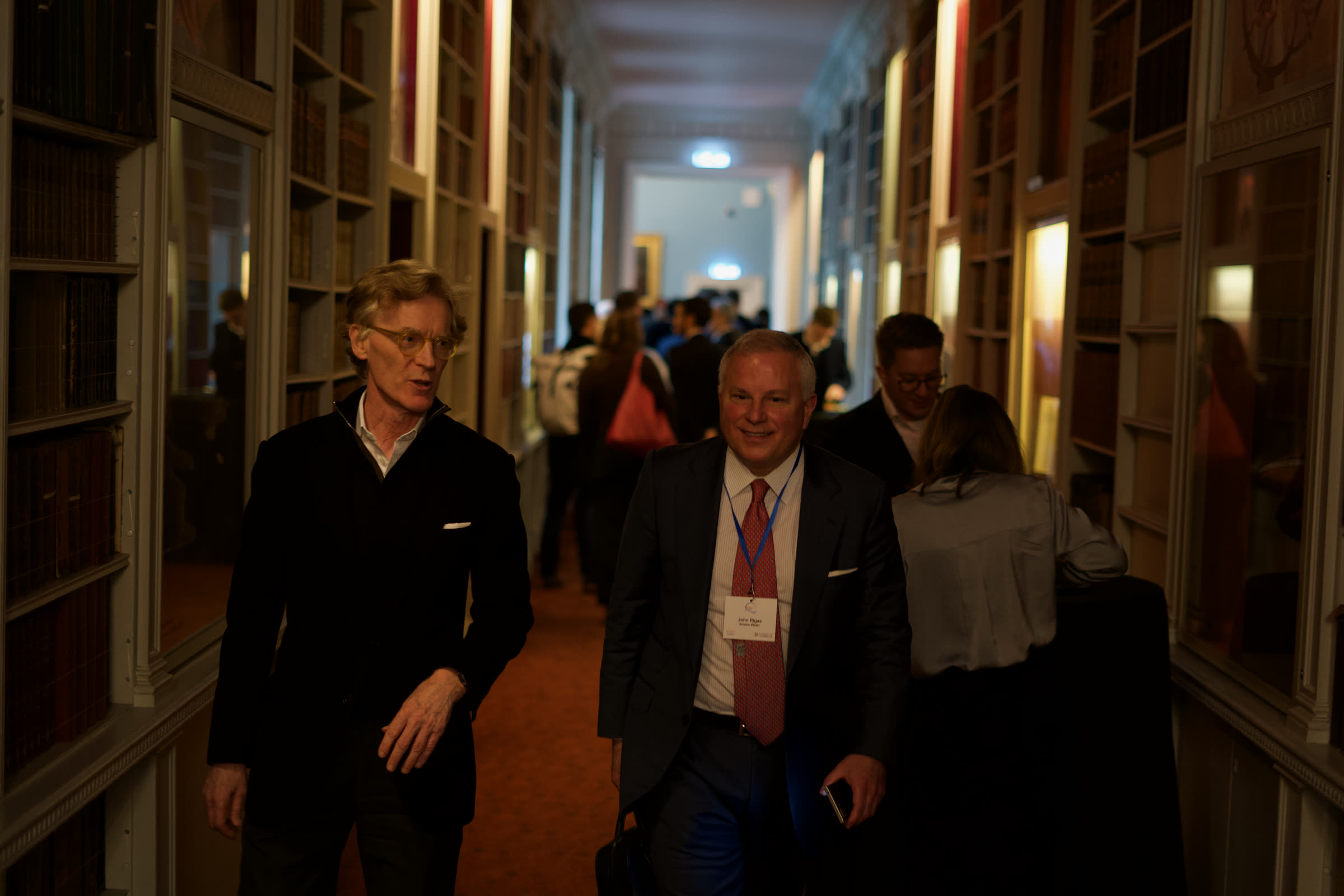 Delegates in conversation along the library corridor