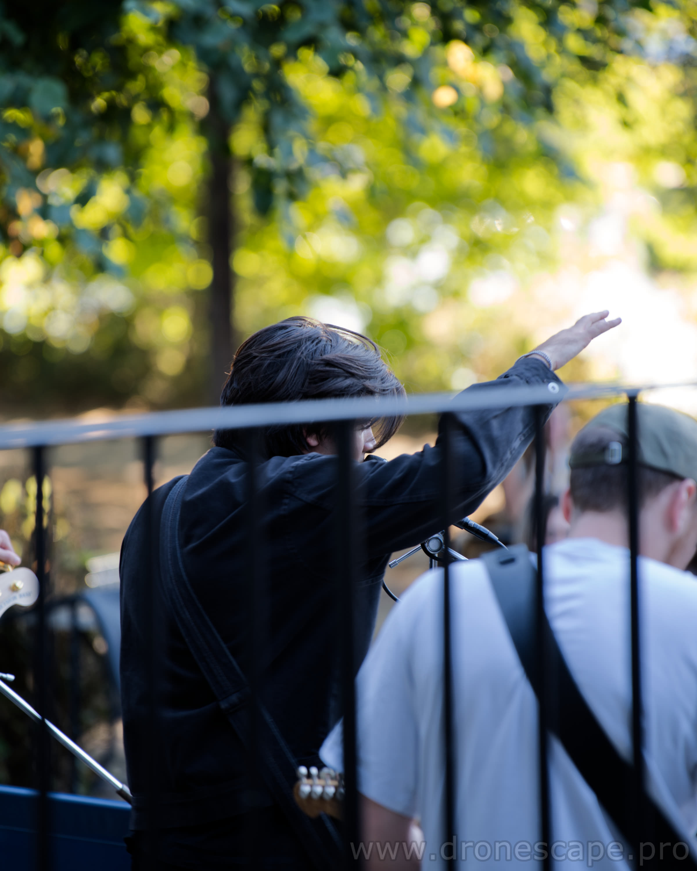 Guitarist reaching out to guests behind the railings