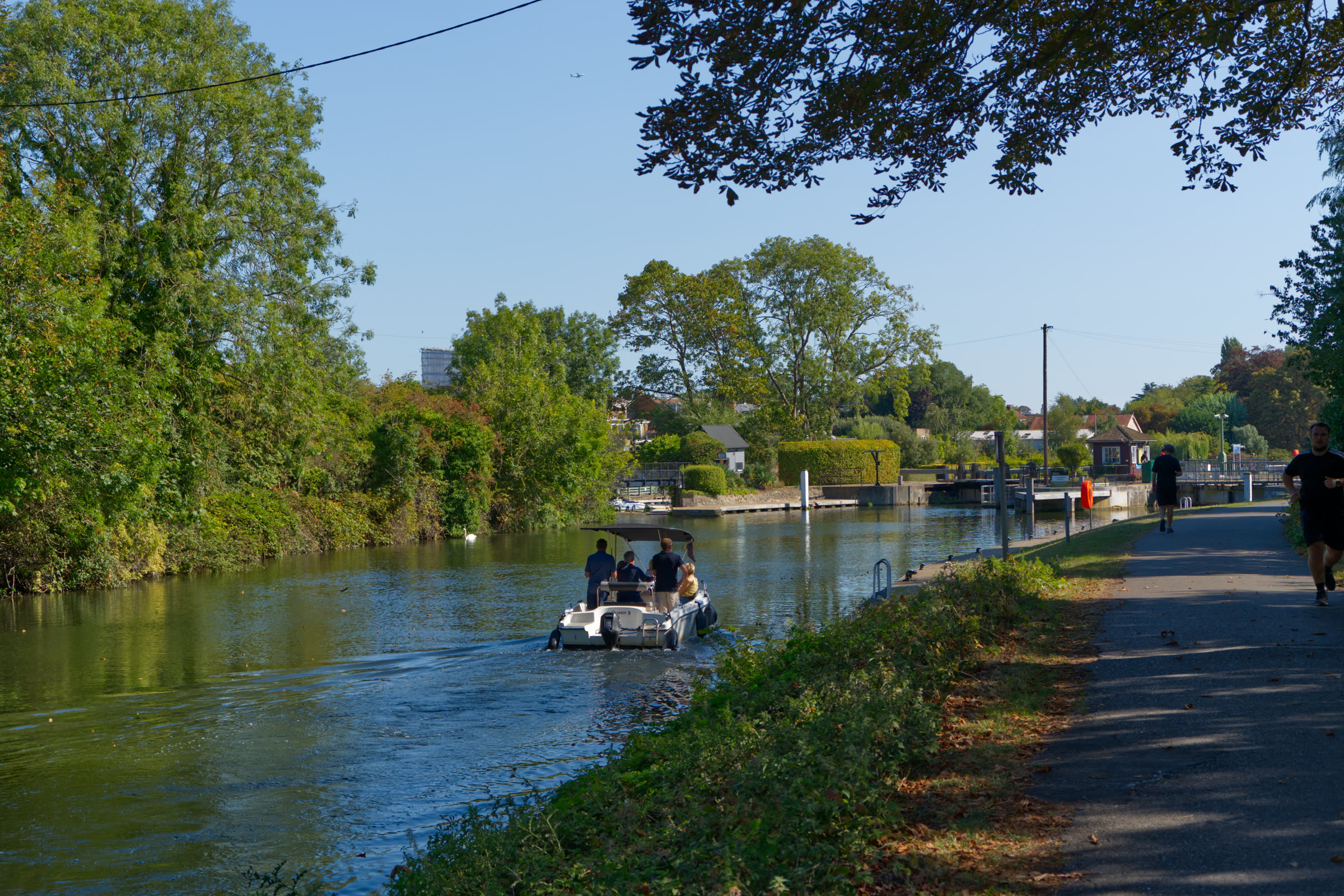 Boat heading upstream alongside the towpath near the venue