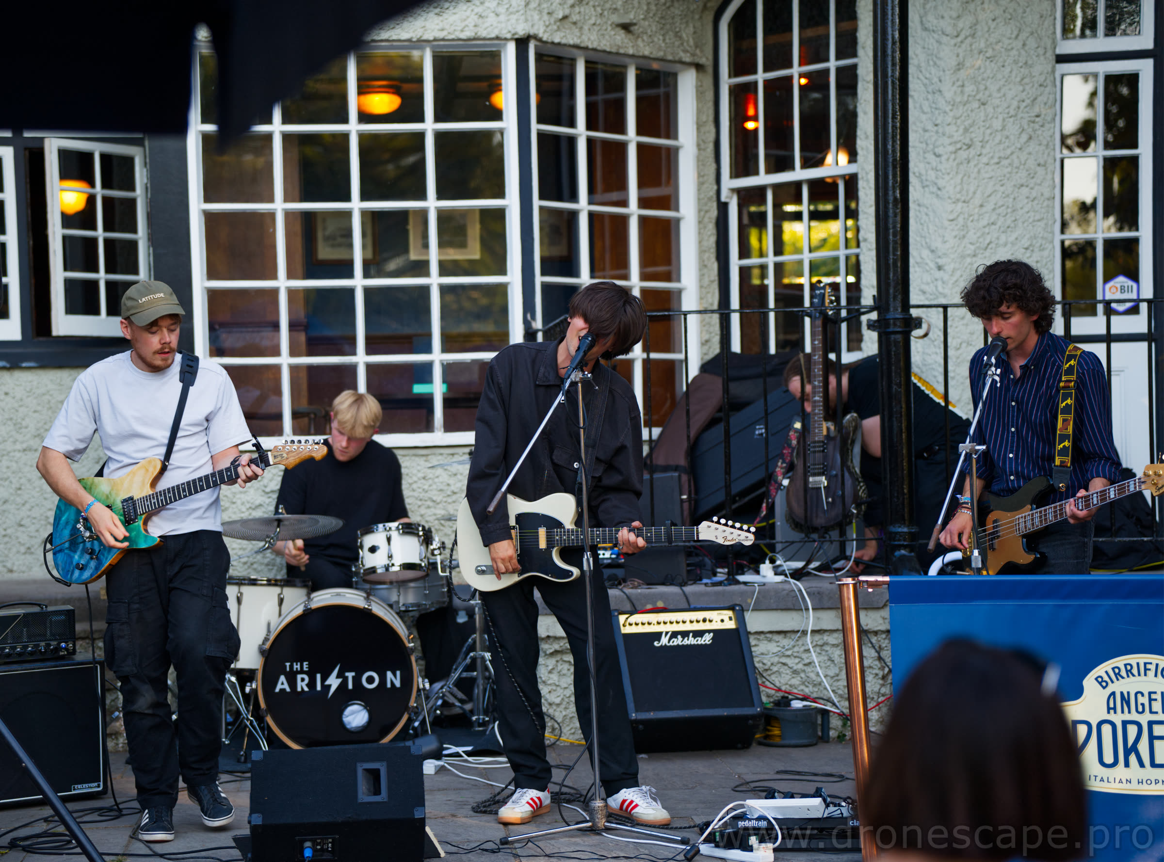 Full band playing on the outdoor stage at the venue